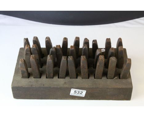 A set of vintage cast iron letter punches with stand. 