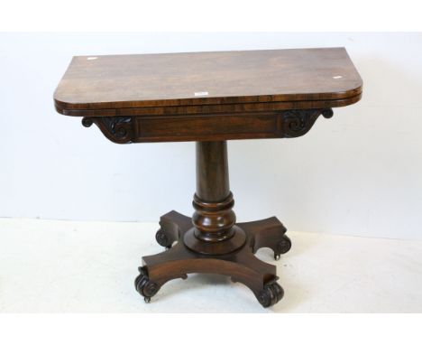 William IV Rosewood fold-over Card Table with purple baise playing surface, raised on a turned pedestal support, shaped platf