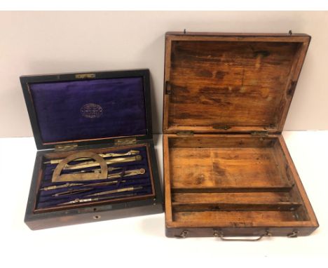 A vintage wooden cased brass drawing instrument set together with a wooden boxed artists pallet.