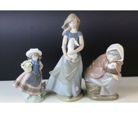 Boxed Lladro Figure ' Sweet Scent ' model no. 05221 together with Two Nao Figures of a Girl holding a Rabbit, 27cms high and 