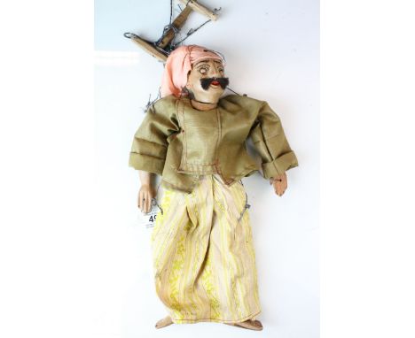 A vintage wooden puppet in the form of a Persian or turkish man in costume 