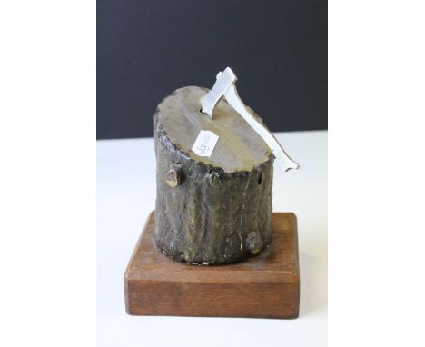 Bronzed and Steel Sculpture of an Axe in a Log, raised on wooden plinth, 13cms high 