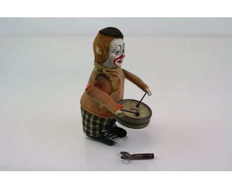 A Vintage Schuco clockwork drumming clown figure complete with key. 