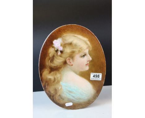 An antique oval porcelain plaque painted with the portrait of a young women signed E J Boys. 