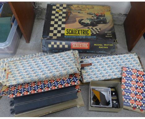 A 1960's Scalextric Grand Prix Series set, also a Tri-ang Scalextric Aston Martin DB4 safety/marshal's car, track, hump-back 