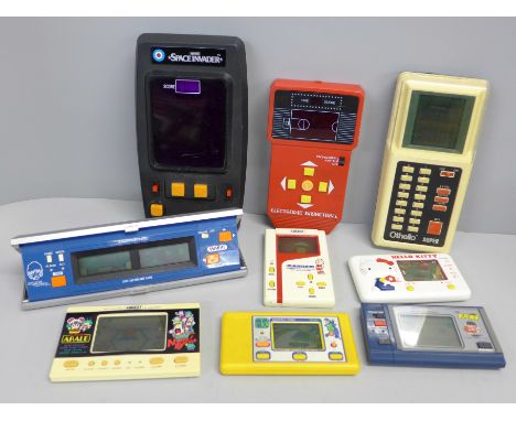Eight vintage hand held games; Space Invaders, Animest Mikketekids, Bandai electronic basketball, Othello, etc. 