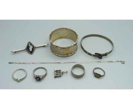 Silver including four rings, a napkin ring, a bangle, a brooch and a bracelet, 40.5g 