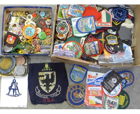 A large collection of cloth and enamel badges including Scouting 
