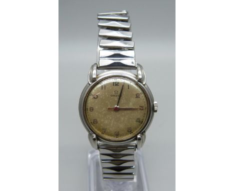 A 1950s gentleman's Omega stainless steel manual wind wristwatch with teardrop lugs and red second hand, 30mm case 
