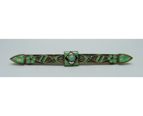 An enamelled and green stone set brooch, 79mm, some enamel a/f 