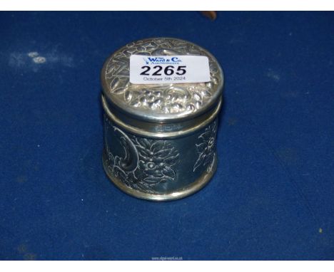 A small Silver cylindrical lidded Pot embossed with flowers, London 1900 by William Hutton & Sons Ltd, 86 gms.