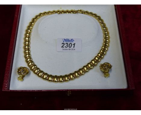A vintage PYC necklace and a pair of similar colour clip on knot design earrings.