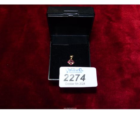A small 9ct gold white stone and ruby pendant. 