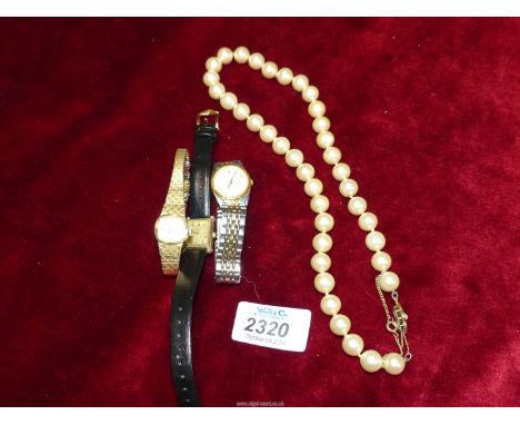 Three ladies wrist watches including a Seiko gold plated wristwatch, Rotary, etc., plus a string of faux pearls.