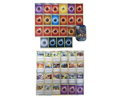 A collection of various 2020-2022 Pokemon Energy, Trainer and Item cards, together with Charizard collectors' tin