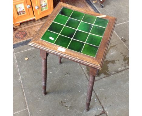 AN EDWARDIAN GREEN TILED TOP OAK TABLE WITH BOBBIN TURNED LEGS