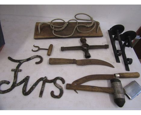 A swing seat, wrought iron sconces, various hand tools