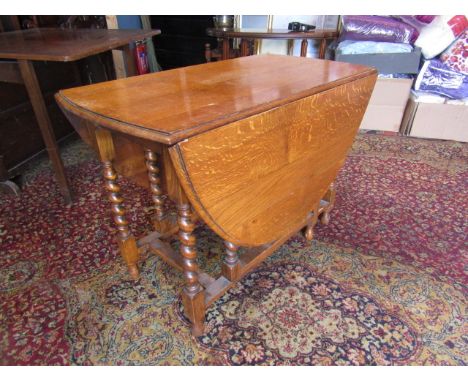 A light oak gate leg table with barley twist legs 104cmW x 54cm/154cm extended