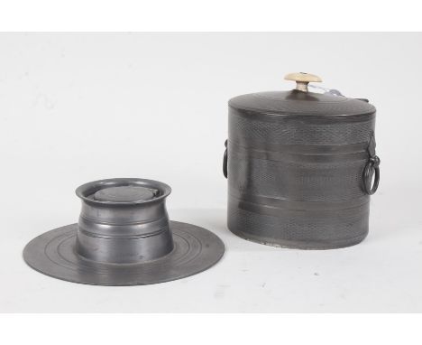 Early 20th Century pewter inkwell, 17.5cm diameter, metal caddy with ring handles and engine turned body, 15cm high (2)