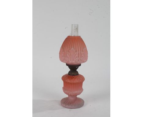 Glass oil lamp, in shades of pink with gadrooned and leaf design, 31cm high 