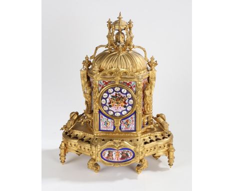 French gilt brass mantle clock, the pierced pediment with bell above a porcelain dial with Roman numerals, flanked by figural