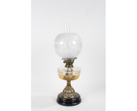 Late 19th/early 20th Century oil lamp, the part frosted glass shade above a clear glass reservoir raised on an Arts and Craft