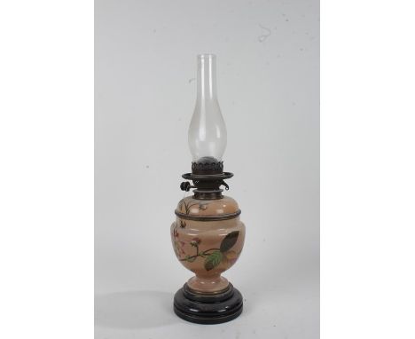 Victorian pottery oil lamp, the glass chimney above the pottery base with leaf and flower decoration, 31cm high