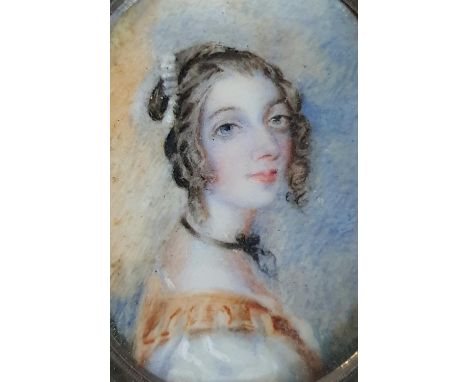 Unsigned Georgian watercolour on plaster oval portrait of a young lady in an ebonised wood frame with hanging clasp