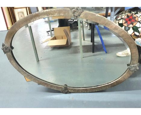 Large, early 20thC oval bevel edged mirror with distressed metal frame 