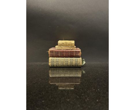 Four old books of religious interest: [a, b] two books of common prayer; [c] one book of psalms with musical notation; [d] on