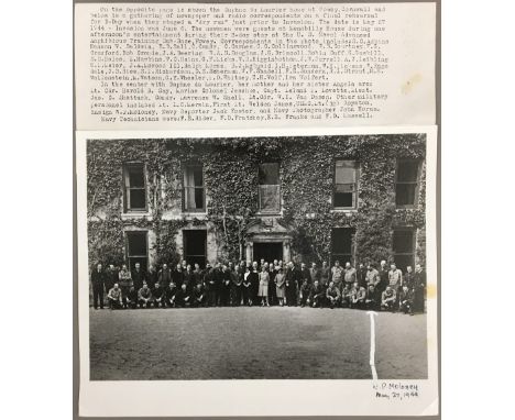 A black and white photographic military print of Daphne du Maurier standing outside Menabilly with newspaper and radio corres