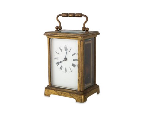 AN ANTIQUE BRASS FRAMED CARRIAGE CLOCK, with glass sides, case &amp; key