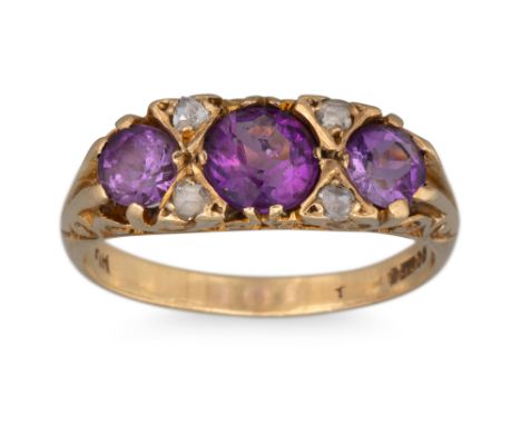 AN ANTIQUE AMETHYST AND DIAMOND THREE STONE RING, the amethyst to rose cut diamond points with engraved setting, mounted in 9