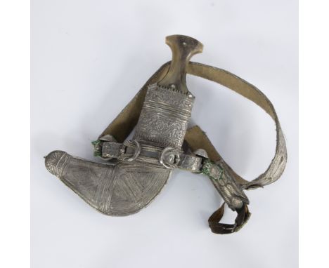 A Saidi Khanjar or Omani dagger with belt, 20th century, traditional curved dagger with beautifully engraved silver-coloured 