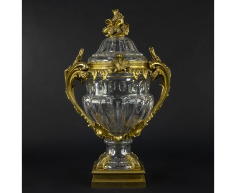 Monumental decorated vase with lid, made of clear cut Baccarat crystal, mounted in richly worked gilt bronze mounts in Louis 