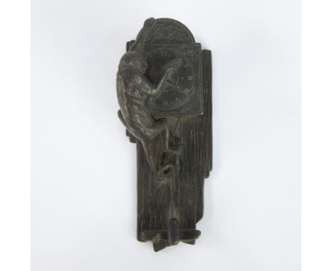 Decorative patinated bronze wall sculpture of a climbing monkey pulling the hands of a clock, style Wiener Werkstätte Austria