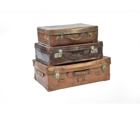Three vintage graduated leather suitcases, the largest with some transit labels applied, 70cm, 61cm and 54cm wide. (3)Footnot