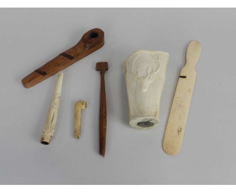 A group of treen and bone carvings, probably Prisoner of War, including a bookmark from Bermuda, a rosewood inlaid pipe, a bo