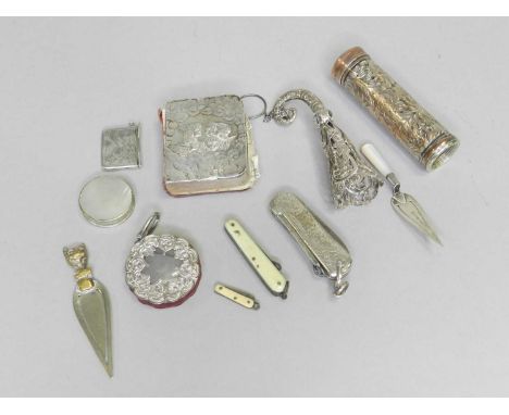 A collection of novelty items, to include; a silver mounted pin wheel, a silver book mark in the form of a trowel, a silver s