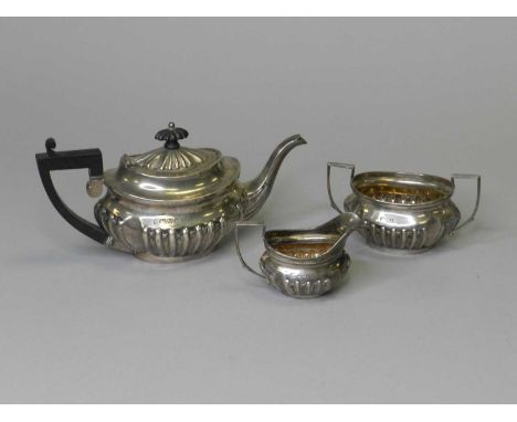 An Edwardian bachelors three piece silver tea service, James Deakin &amp; Sons, Chester, 1901, each piece of oval reeded form