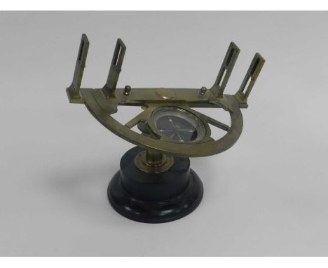 A 19th-century brass graphometer, semi-circular frame with 180-degree scale and adjustable sights, inset glazed compass on an