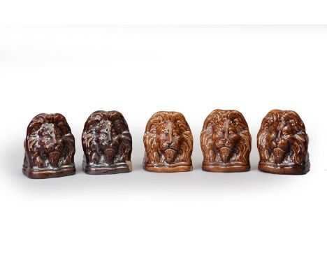 Five English treacle-glazed pottery lion-head sash window stops, 19th century, 12.5cm high (three chipped)Footnote: Provenanc
