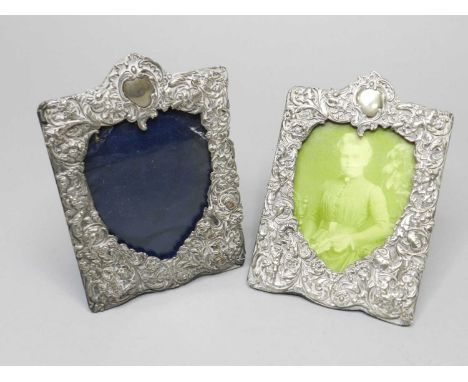 A pair of Victorian silver mounted frames, William Comyns, London 1891, each with embossed figural and floral decoration, 19c