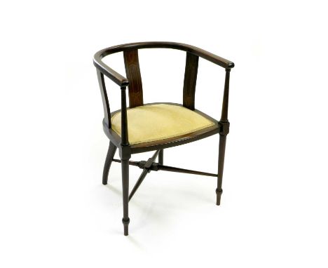 An Edwardian inlaid mahogany open armchair, with horse-shoe top rail on rectangular splats above a padded seat, raised on tap