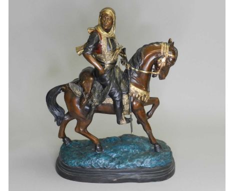 A patinated and painted spelter equestrian model of a middle-eastern gentleman riding a horse with dead game, on a stimulated