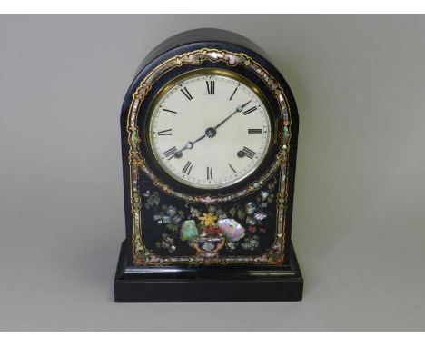 A 19th century arched, ebonised, mantel clock, probably with an American 8-day movement, the front inlaid with abalone and mo