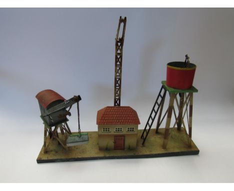 A Kibri 0 gauge model railway tinplate goods depot with water tower, crane and building mounted on base 