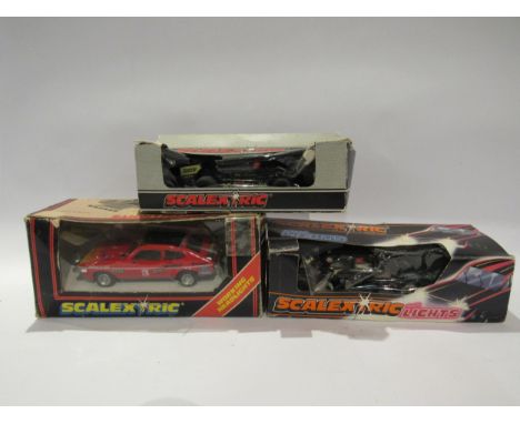Three boxed Scalextric slot racing cars to include C106 World WR5 Blue Formula 1 Car, C118 Ford Escort with lights and C300 C