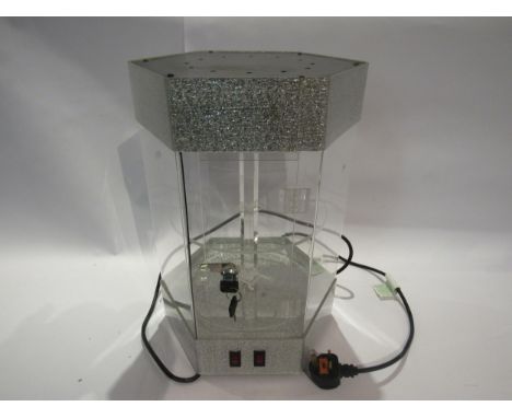 A hexagonal light up perspex display case wuth rotating shelves, 44cm tall, with key 