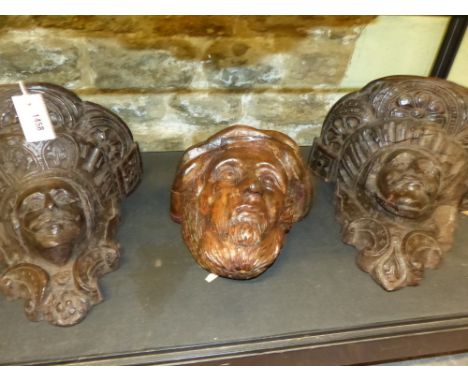 A PAIR OF EARLY CARVED OAK BRACKETS OR CORBELS WITH PORTRAIT MASK SUPPORTS AND A PORTRAIT APPLIQUE OF A BEARDED MAN.   H.30cm